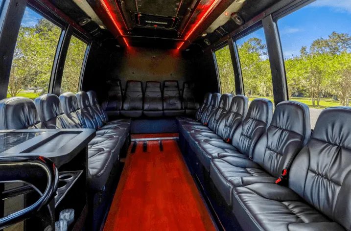 Executive Limousine Bus for party bus rental: seating area, with perimeter lounge seating and LED ceiling lighting Executive Limousine Bus for party bus rental: seating area, with perimeter lounge seating and LED ceiling lighting
