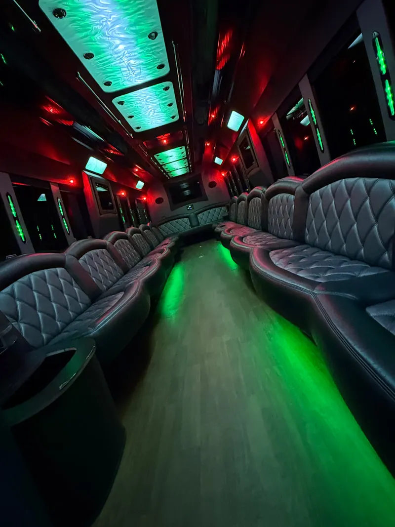 Freightliner Party Bus: seating area, with perimeter lounge seating, LED ceiling lighting and wood-look flooring, pic 10 Freightliner Party Bus: seating area, with perimeter lounge seating, LED ceiling lighting and wood-look flooring, pic 10