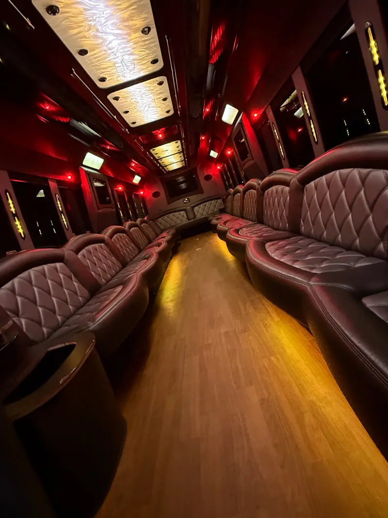 Freightliner Party Bus: seating area, with perimeter lounge seating, LED ceiling lighting and wood-look flooring, pic 12 Freightliner Party Bus: seating area, with perimeter lounge seating, LED ceiling lighting and wood-look flooring, pic 12