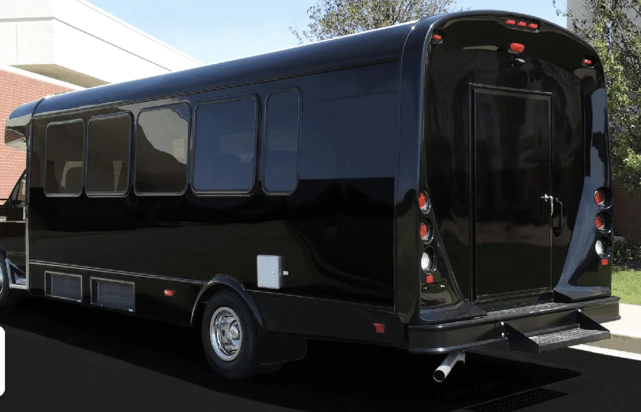 Limousine Coach (black) for party bus rental: full view, with tinted windows Limousine Coach (black) for party bus rental: full view, with tinted windows