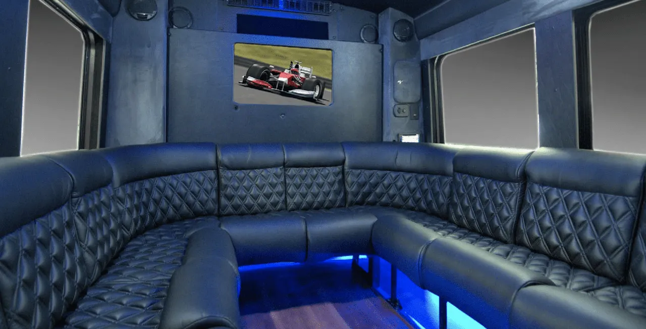 Limousine Coach for party bus rental: seating area, with perimeter lounge seating, sofa-style seating and LED accent lighting Limousine Coach for party bus rental: seating area, with perimeter lounge seating, sofa-style seating and LED accent lighting